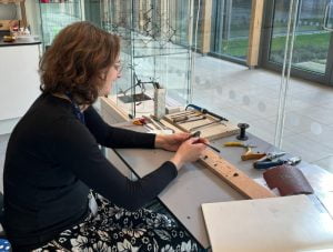 Briony Marshall STEM-artist in residence working at her desk in the new Sci-tech complex