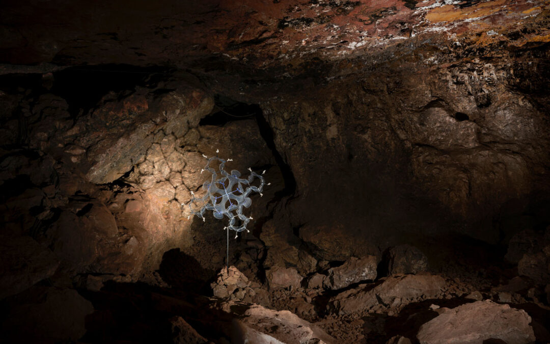 Image of the scupture Nature's Blueprint, by Briony Marshall, in a dark cave, during the exhibition Back to the Cave - the Full Spectrum