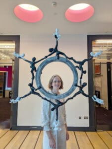 Briony looking through her Kathleen Lonsdale Benzene Monument Sculpture