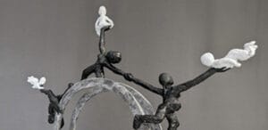 Plaster maquette of a monument to Kathleen Lonsdale. It shows 3 female figures stretched between different responsibilities of family, work and supporting each other.