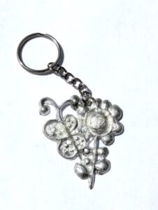 keychain with a pewter pendant of a flower and a butterfly